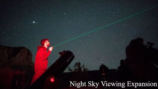 A person in a red sweatshirt uses a laser pointer to point at the night sky, with a title in the lower-right hand corner that says 