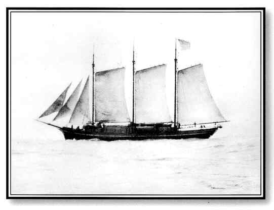 A black and white image of the C.A. Thayer at sea with all sails open