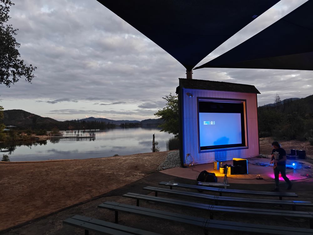 The Whiskeytown amphitheater at sunset with the audio-visual screen lit up