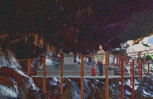 A mock-up image of people standing on a boardwalk with railings inside of a lava tube