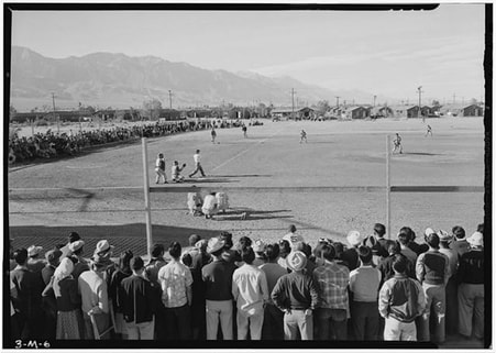 Historic Ansel Adams photo of incarcerees playing baseball at Manzanar