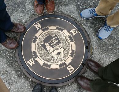 A compass rose with the National Park Service logo orients visitors at San Francisco Maritime