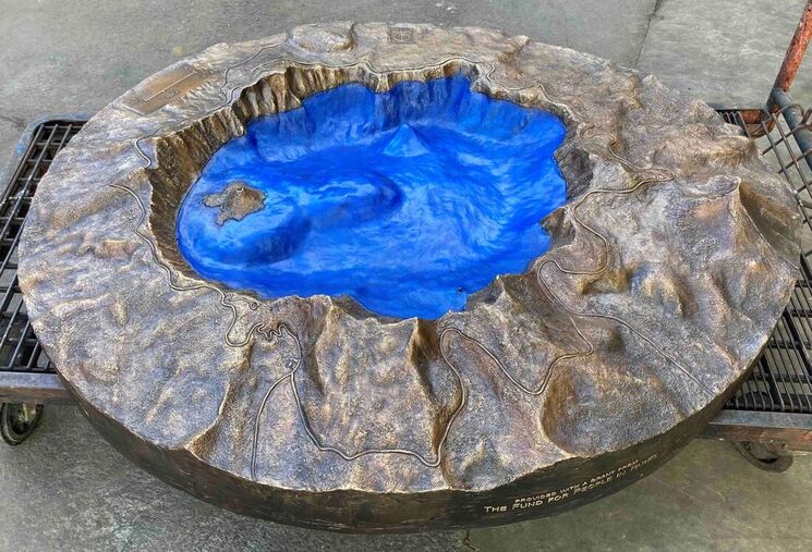 Bronze sculpture of Crater Lake sits on a dolly