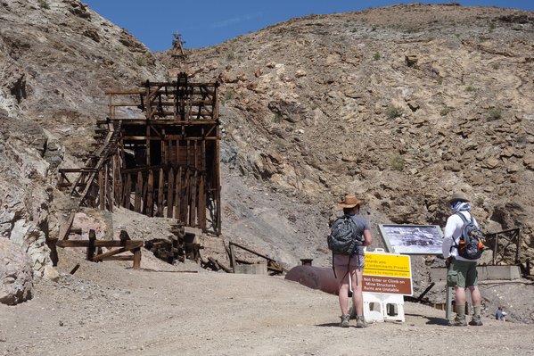 Visitors read a wayside educational sign at the Keane Wonder Mine