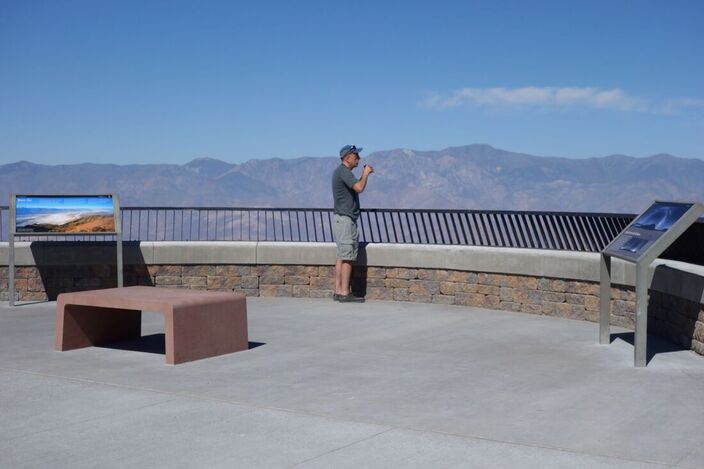 A visitor looks out over the landscape at the newly-renovated Dantes View