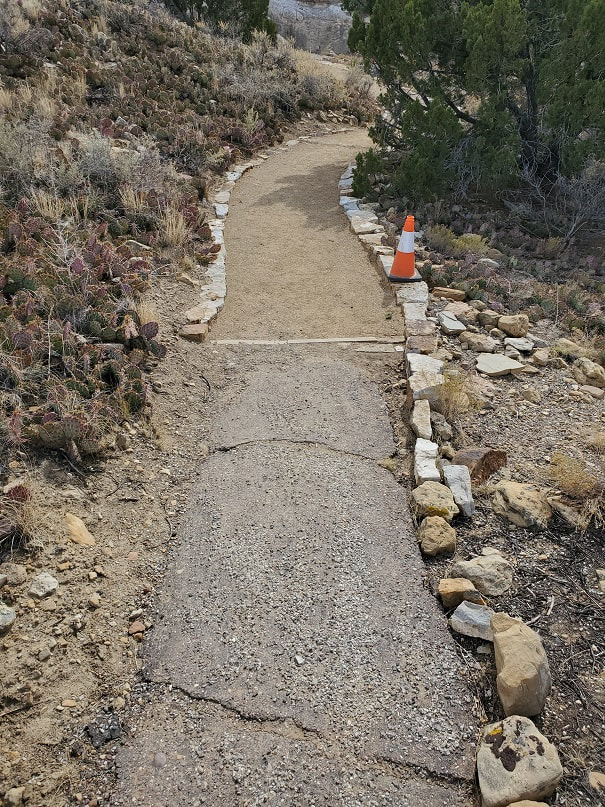 A segment of trail showing both the old asphalt and the newer resurfaced work