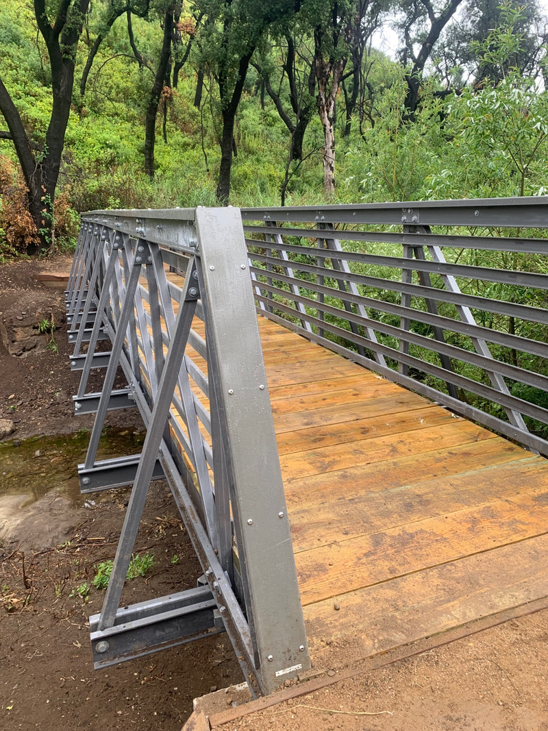 An up close look at the new bridge with wooden slats and metal struts