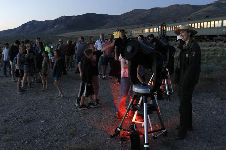 A ranger leads an astronomy program for a group of visitors