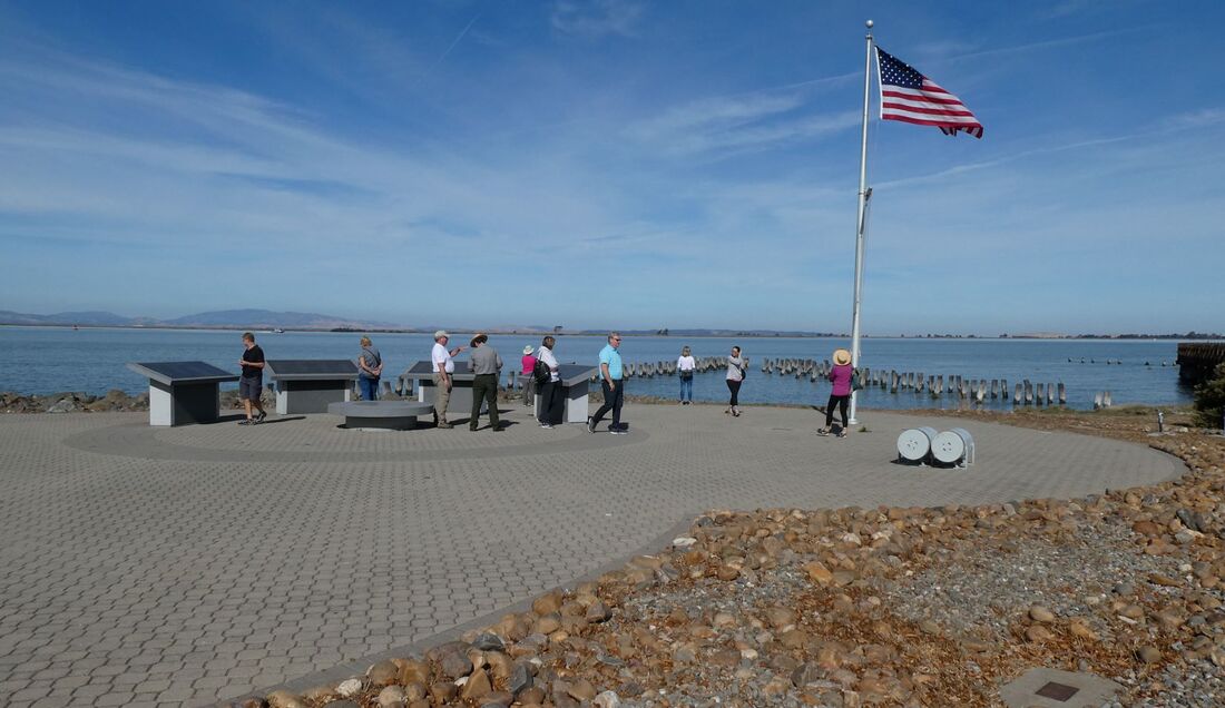 A group of people with a ranger gather at Port Chicago Naval Magazine National Memorial