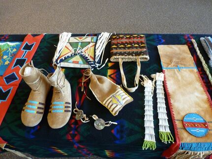 A display of items made with traditional Nez Perce artisanry techniques sits on a table